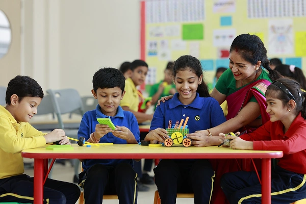 Teacher nurturing sensitivity, empathy, and inclusive learning with students at TSUS Noida